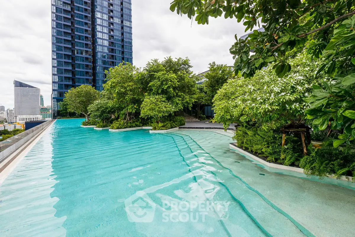 Luxurious rooftop pool with stunning city views and lush greenery in a modern high-rise building.