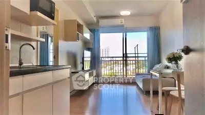 Modern open-layout living room with balcony view in a stylish apartment