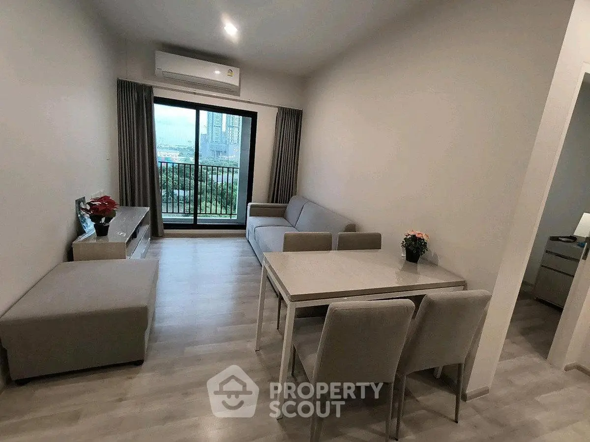 Modern living room with balcony view, stylish furniture, and air conditioning.