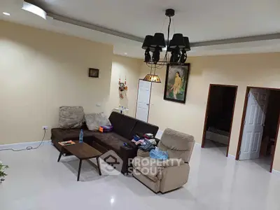 Spacious living room with modern furniture and elegant lighting, perfect for family gatherings.