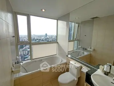 Luxurious bathroom with city view and modern bathtub in high-rise apartment.