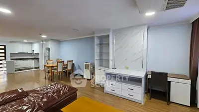 Spacious open-plan living room with modern kitchen and dining area.