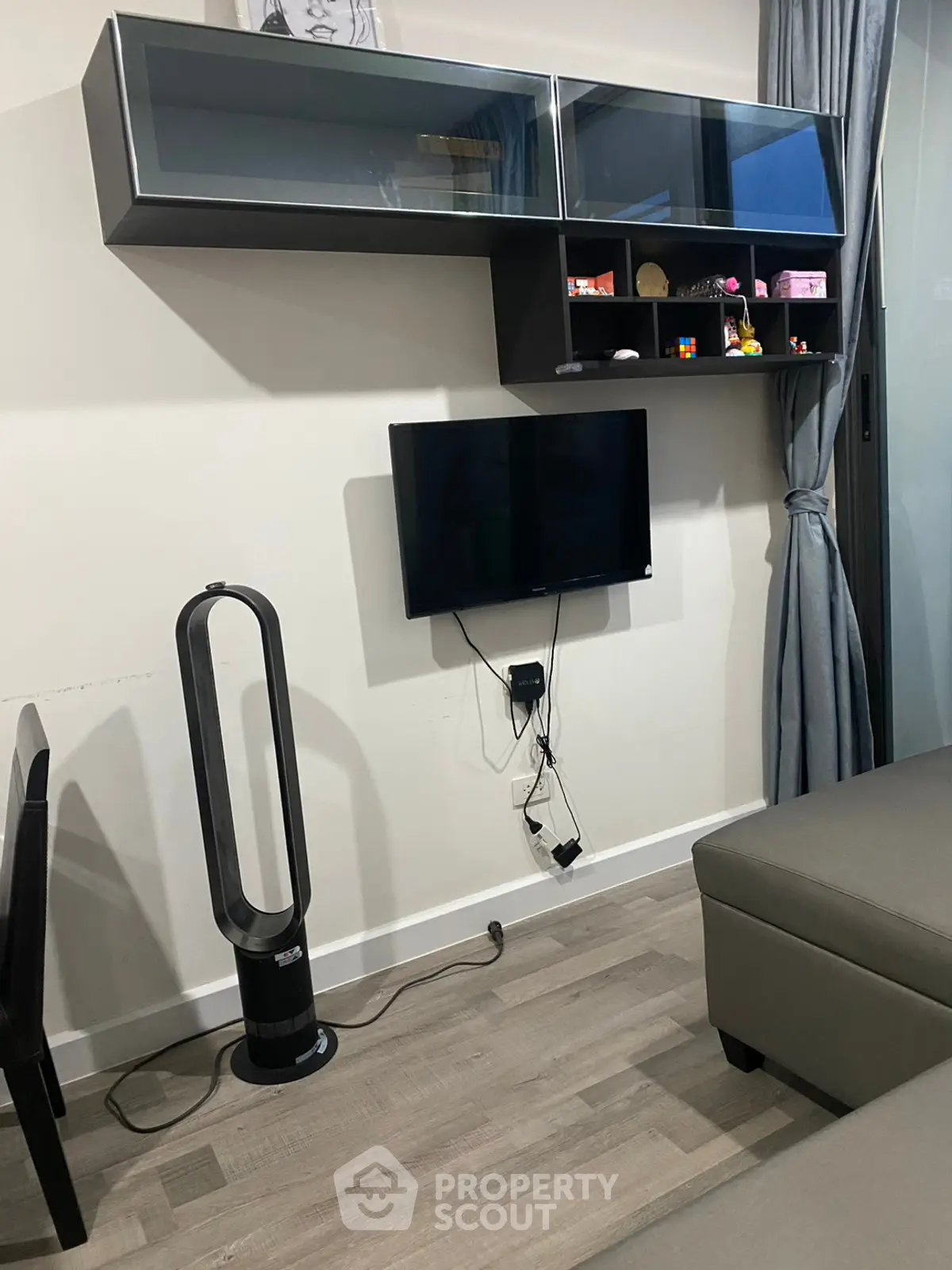 Modern living room with sleek furniture and wall-mounted TV