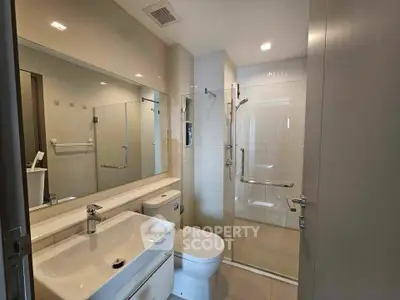 Modern bathroom with sleek fixtures and spacious shower area