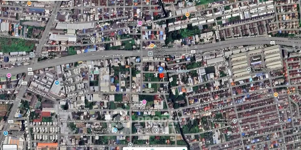 Aerial view of urban residential and commercial area with roads and buildings.