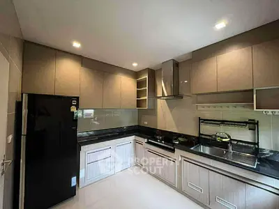 Modern kitchen with sleek cabinetry and gas stove in a contemporary home.