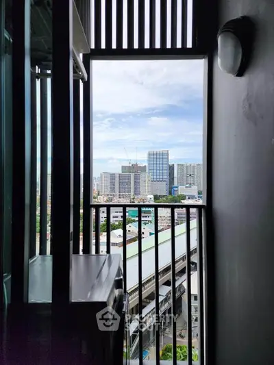 Stunning urban view from a high-rise balcony with cityscape backdrop.