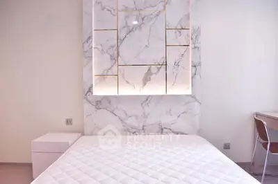 Modern bedroom with elegant marble accent wall and minimalist design