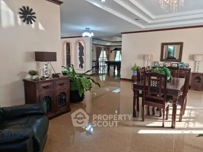 Spacious living and dining area with elegant wooden furniture and natural light.