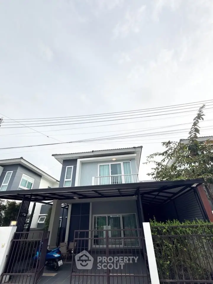 Modern two-story house with carport and sleek exterior design