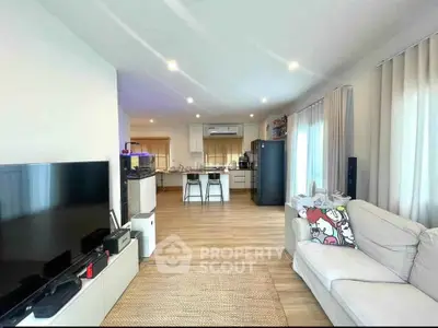 Spacious open-plan living room with modern kitchen and cozy seating area
