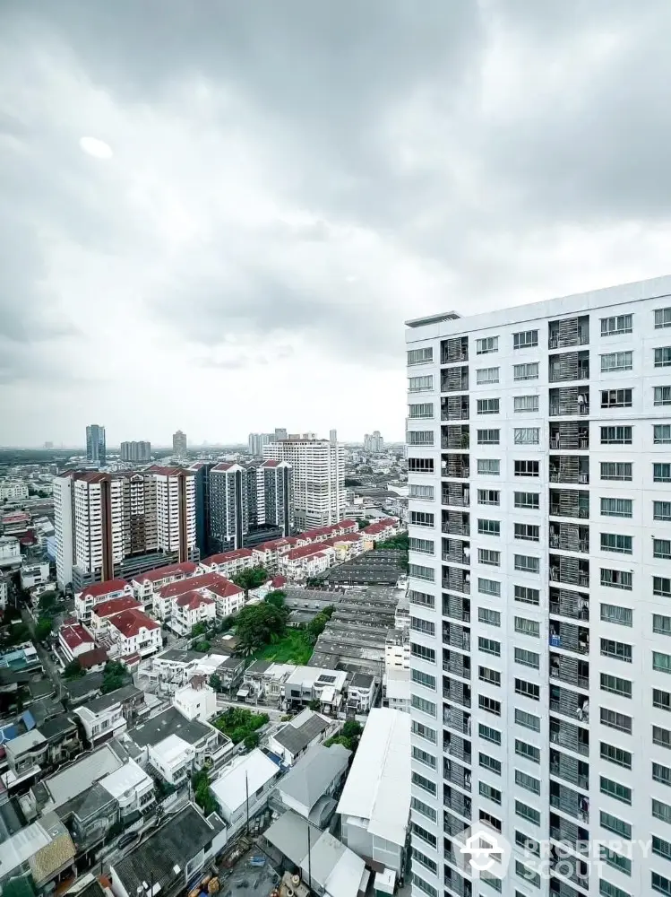 Stunning cityscape view from high-rise apartment showcasing urban living and modern architecture.