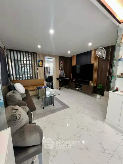 Spacious modern living room with sleek design and ample seating, perfect for relaxation and entertainment.