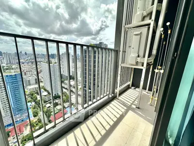 Stunning high-rise balcony with panoramic city views and modern railing design.