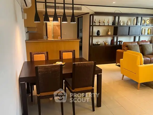 Stylish open-plan living room with modern dining area and cozy seating.