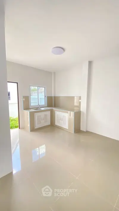 Bright minimalist kitchen with closed layout and garden view