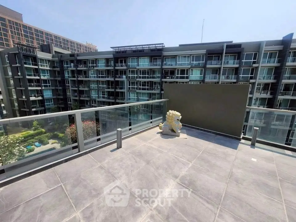 Spacious rooftop terrace with city view in modern apartment complex