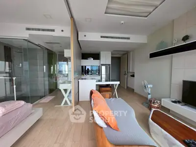 Modern open-plan living room with sleek kitchen and cozy seating area