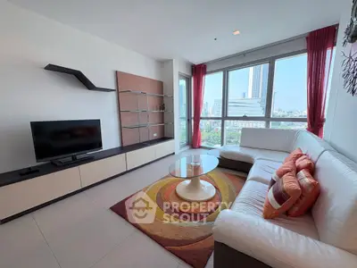 Modern living room with city view, stylish furniture, and vibrant decor in a high-rise apartment.