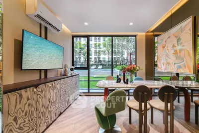 Luxurious dining room with modern decor and large windows overlooking a garden view.
