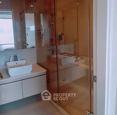 Modern bathroom with glass shower and sleek sink design