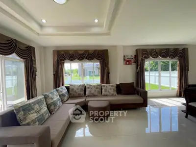Spacious living room with elegant drapery and ample natural light