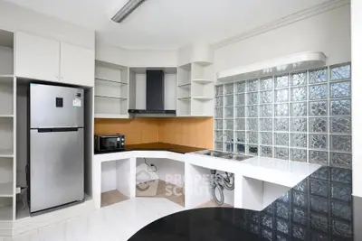 Modern kitchen with sleek appliances and glass block wall