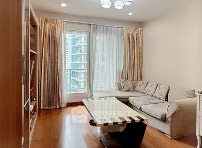 Elegant living room with modern decor and large window offering city view