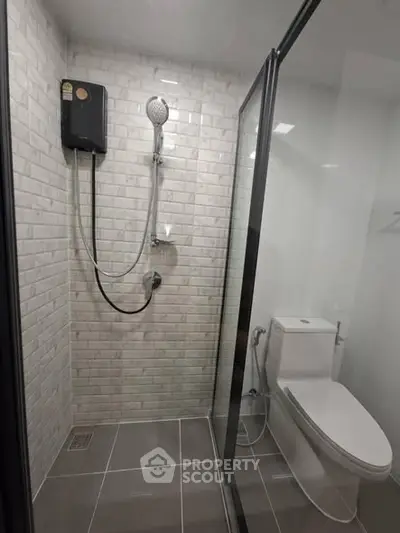 Modern bathroom with glass shower enclosure and sleek tile design