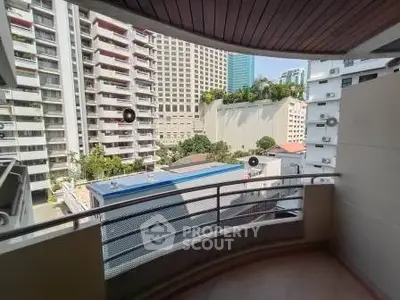 Spacious balcony with city view in modern apartment building