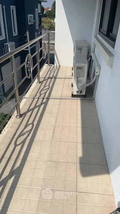 Spacious balcony with modern railing and air conditioning units