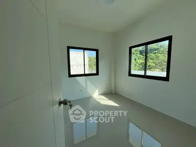 Bright empty room with large windows and glossy tiled floor, perfect for customization.