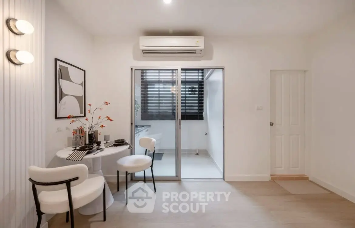 Modern dining area with stylish decor and air conditioning in a cozy apartment.