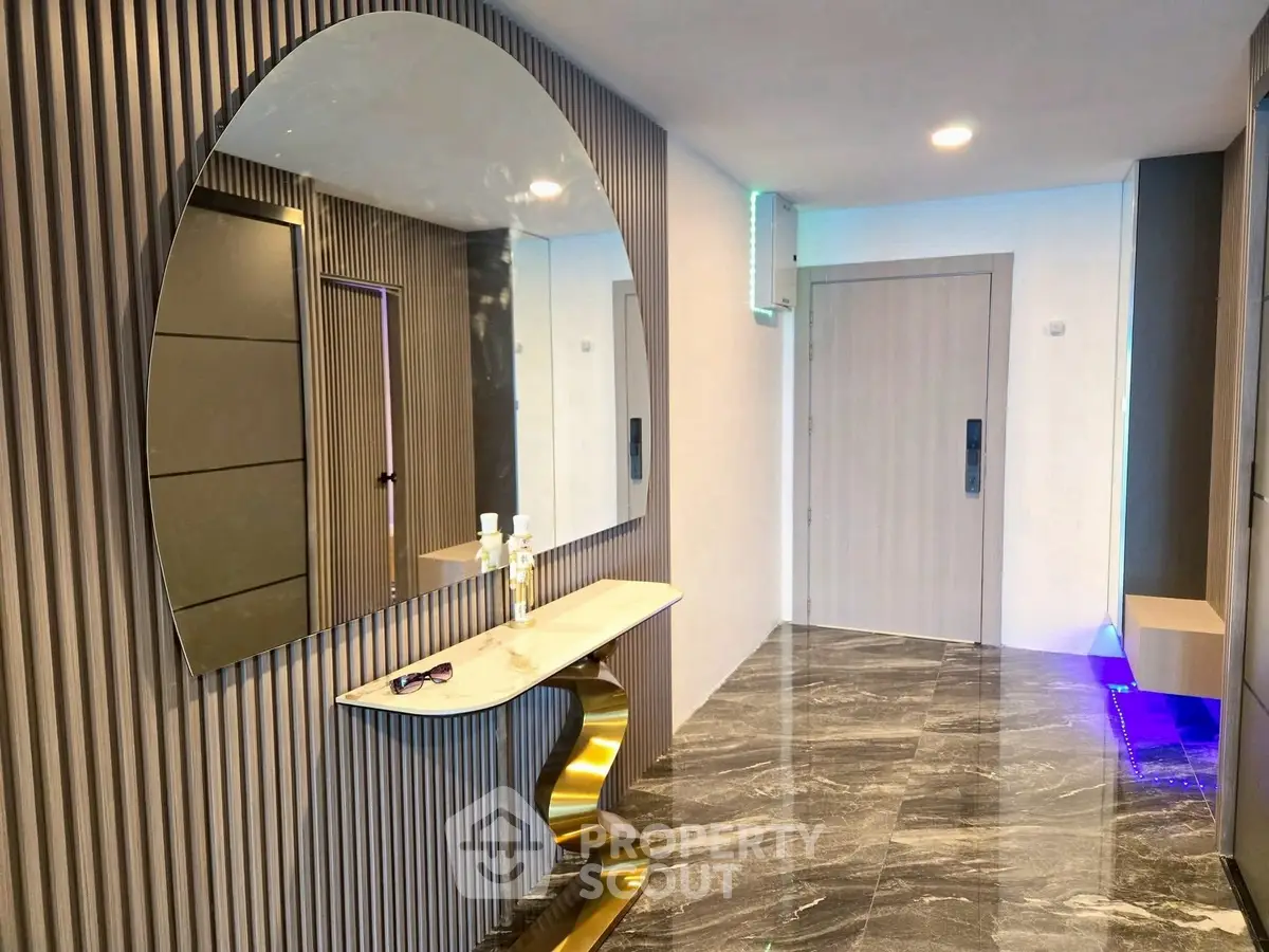 Stylish modern hallway with marble flooring and elegant mirror