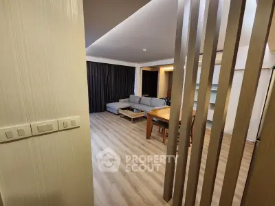 Spacious modern living room with wooden flooring and stylish furniture