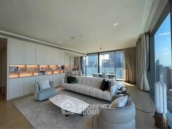 Luxurious modern living room with panoramic city views and elegant furnishings.