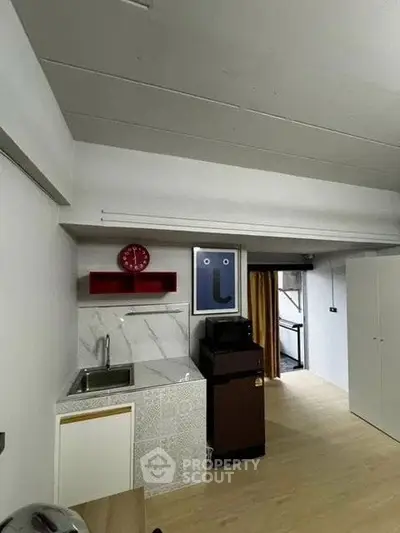 Compact kitchen area with modern design and open layout in a cozy apartment.
