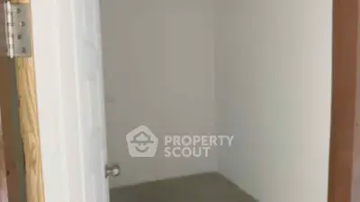 Minimalist storage room with white walls and concrete floor