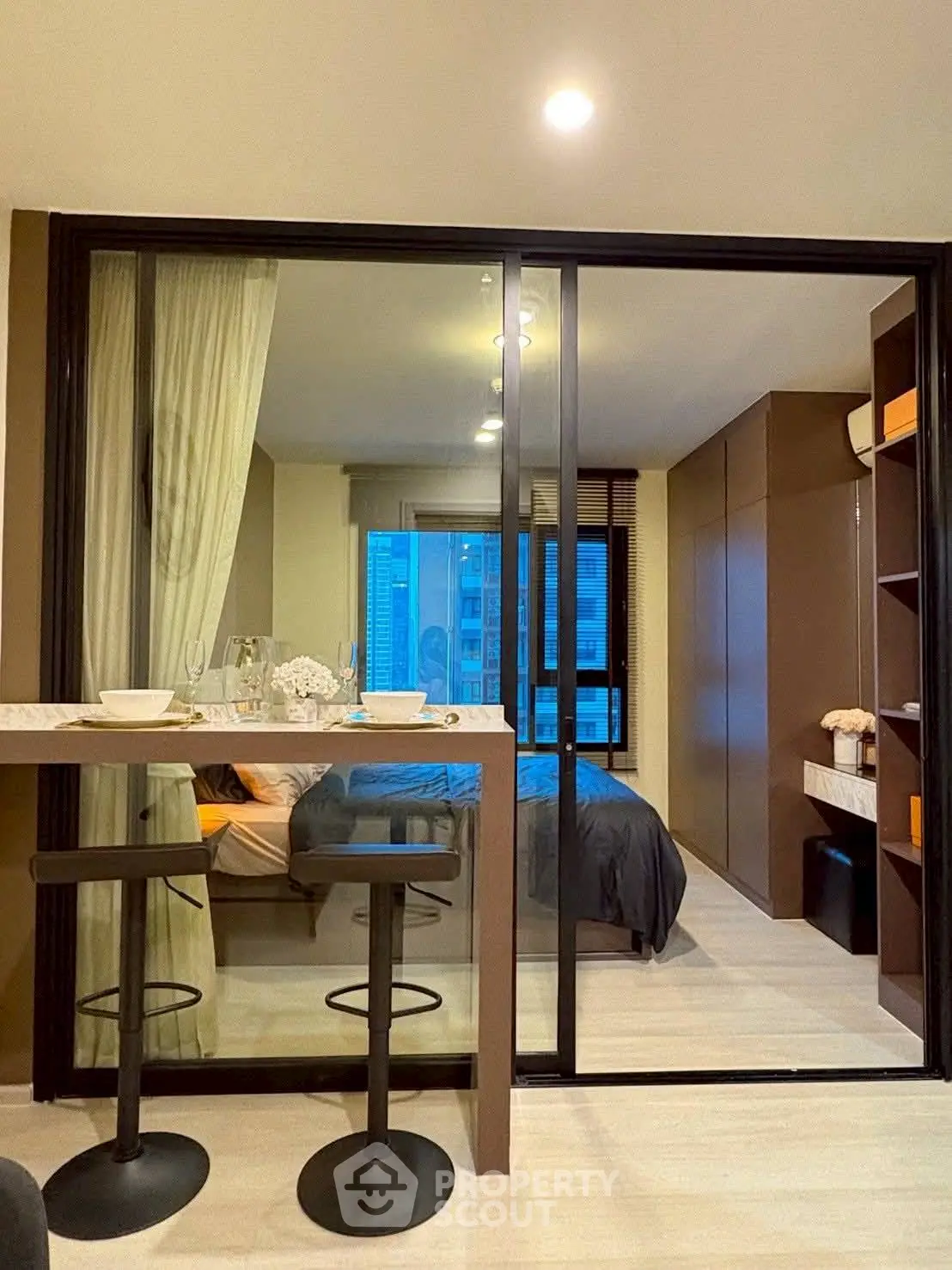 Modern studio apartment with glass partition and cozy decor