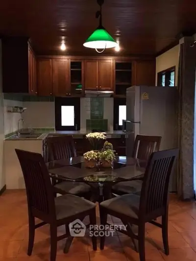 Charming kitchen with wooden cabinets and dining area, perfect for cozy family meals.