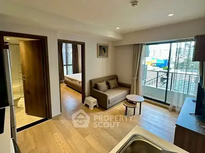 Modern apartment interior with open living area and balcony view.