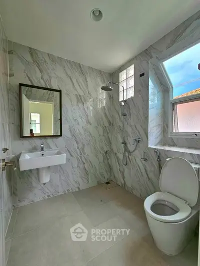 Modern bathroom with marble tiles and sleek fixtures