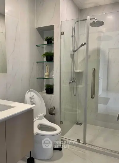 Modern bathroom with glass shower and sleek fixtures, perfect for a contemporary home.
