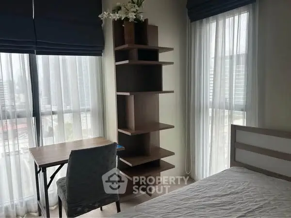 Bright bedroom with modern shelving and city view, perfect for urban living.