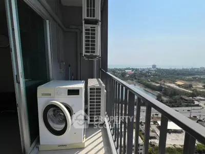 High-rise balcony with washing machine and stunning city view