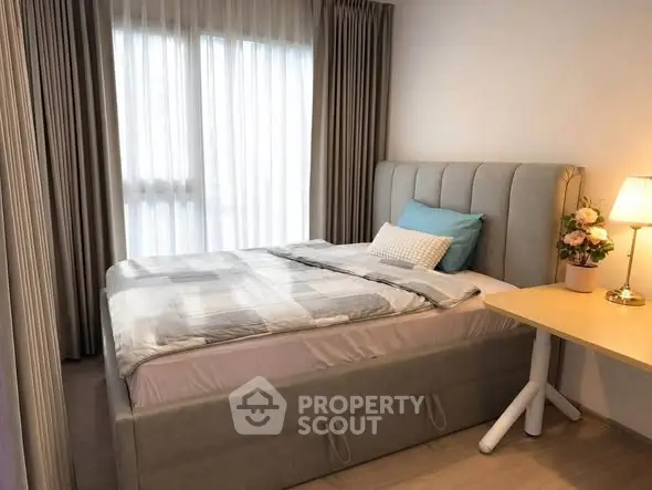Cozy bedroom with stylish decor and natural light, perfect for relaxation and comfort.