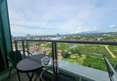 Stunning high-rise balcony view overlooking cityscape and lush greenery