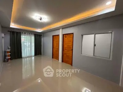 Spacious modern living room with elegant lighting and large windows.
