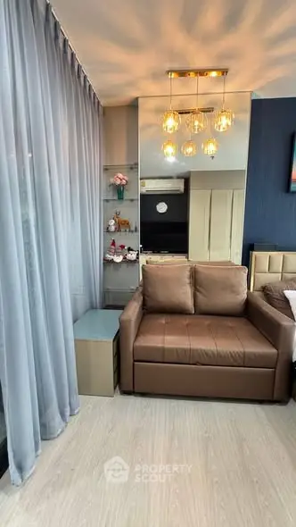 Modern living room with elegant lighting and cozy brown sofa, featuring floor-to-ceiling curtains and stylish decor.