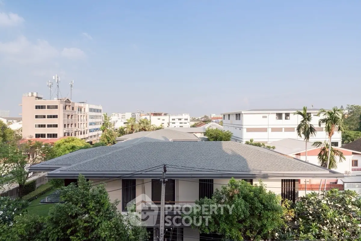 Modern residential building with lush greenery and clear blue sky
